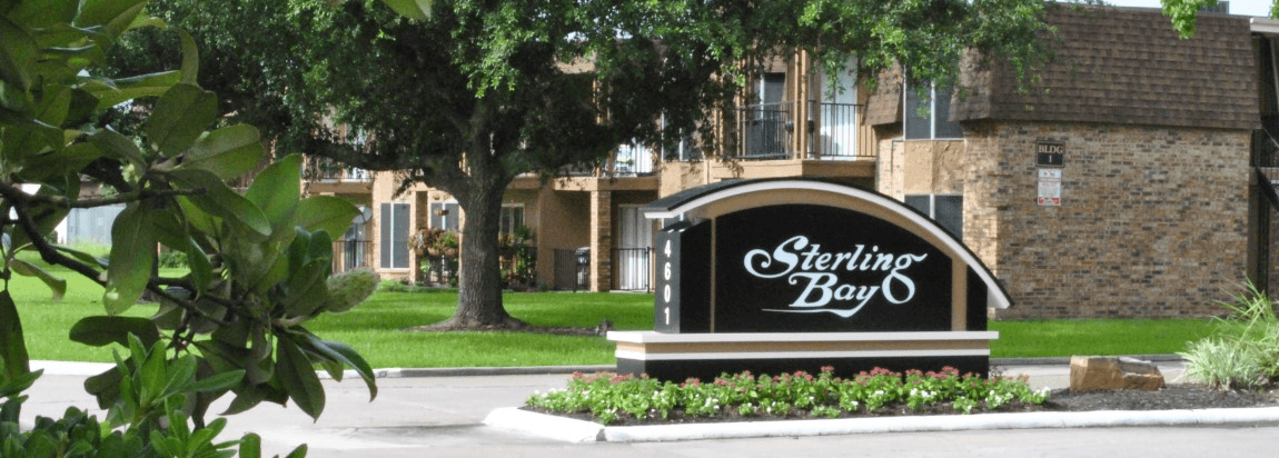 a sign that says sparkling bay in front of a brick building